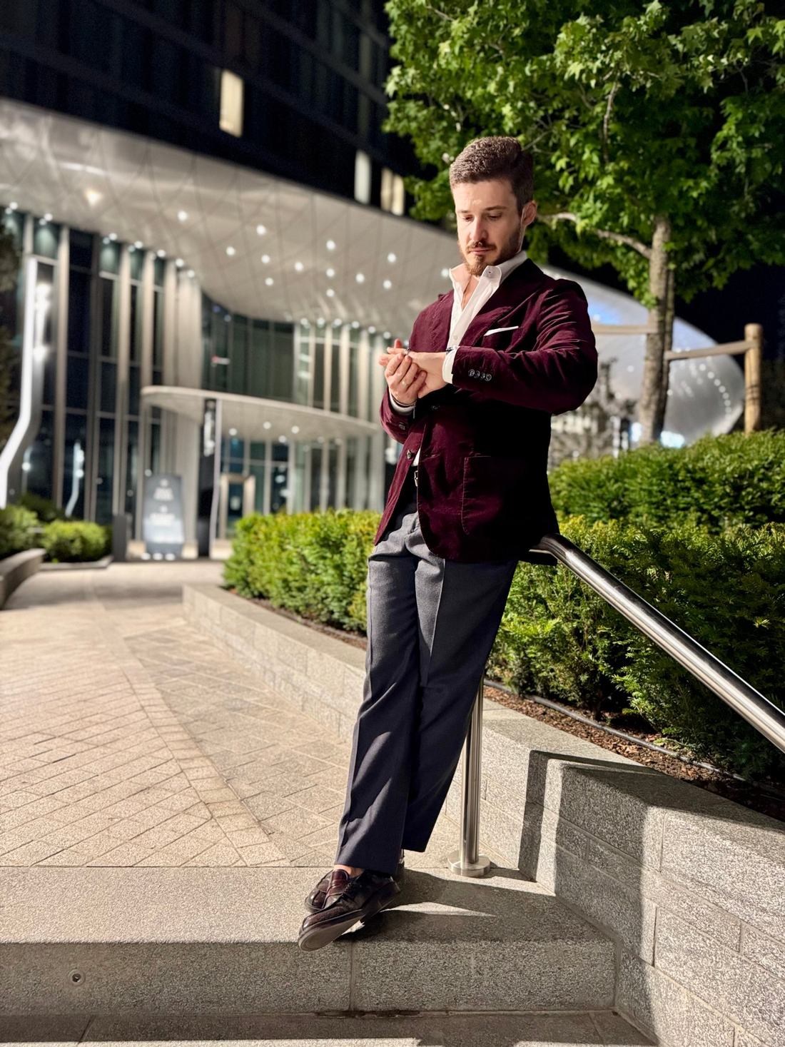 Personal stylist in a burgundy velvet blazer at night