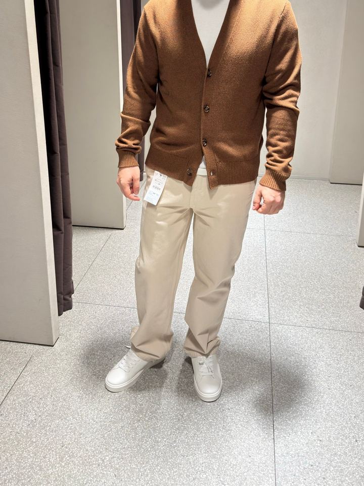 Brown cardigan over a white t-shirt with cream trousers