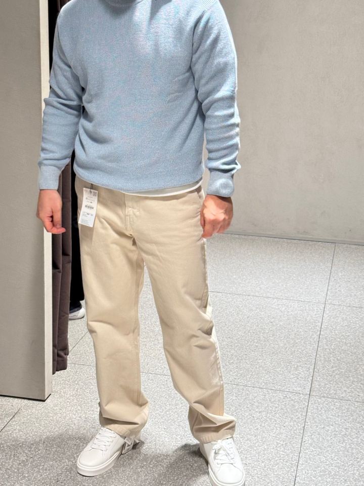 Light blue sweater with cream trousers