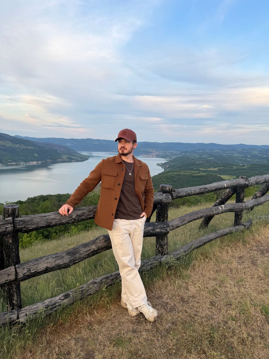 Brown overshirt with cream trousers outdoors