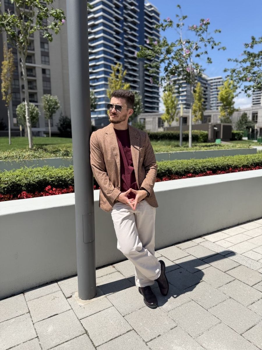 Brown textured blazer with burgundy t-shirt and cream trousers
